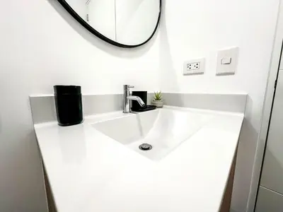 a bathroom with a white sink and a mirror at Hermoso departamento de estreno in Lima