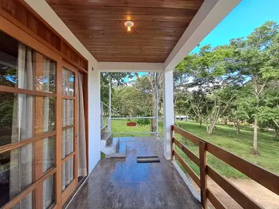an empty porch of a house with a wooden door at Bellavista Hospedaje Vista asombrosa in Oxapampa