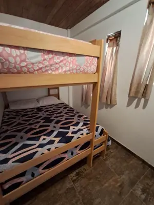 a bedroom with a bunk bed in a room at Bellavista Hospedaje Vista asombrosa in Oxapampa