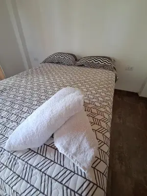 a bed with two white pillows on top of it at Bellavista Hospedaje Vista asombrosa in Oxapampa