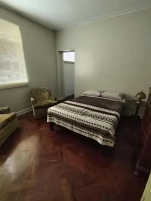 a bedroom with a large bed and a wooden floor at Spacious apartment - San Isidro in Lima