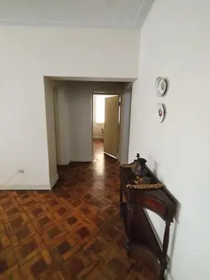 an empty room with a table and a hallway at Spacious apartment - San Isidro in Lima