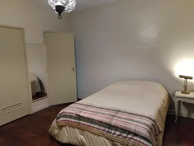 a bedroom with a bed and a door and a lamp at Spacious apartment - San Isidro in Lima