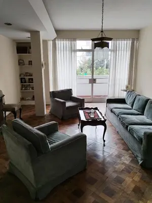 a living room with couches and a coffee table at Spacious apartment - San Isidro in Lima