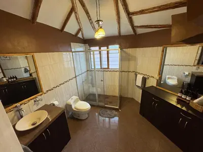 a bathroom with a toilet and a shower and a sink at Urquillos Wasi - Andean Cottage in Urubamba