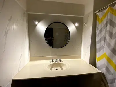 a bathroom with a sink and a mirror at Elegant and spacious penthouse in Lima