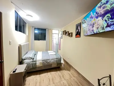 a room with a bed and a table in it at Habitaciones privadas para alojamiento en Ica, Perú in Ica