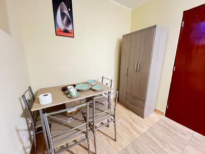 a room with a small table and a cabinet at Habitaciones privadas para alojamiento en Ica, Perú in Ica