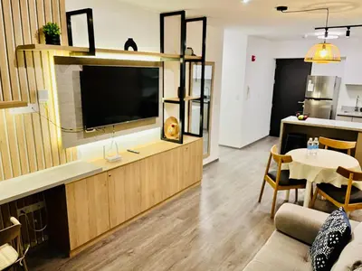 a living room with a tv and a table at Beautiful cozy apartment in Cusco