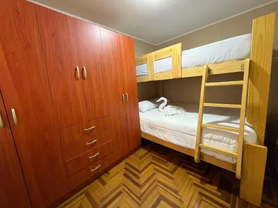 a bedroom with two bunk beds and a closet at Departamento privado en Lima in Lima