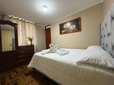 a bedroom with a bed with a bow on it at Departamento privado en Lima in Lima