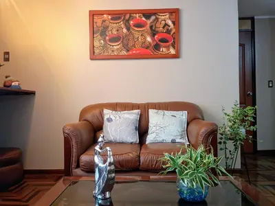 a brown leather couch sitting in a living room at Departamento privado en Lima in Lima
