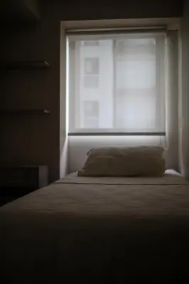 a bedroom with a bed and a window with a pillow at Lovely apartment in Lima