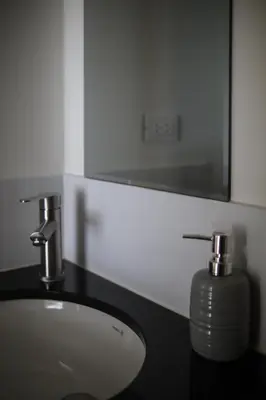 a bathroom with a sink and a mirror at Lovely apartment in Lima