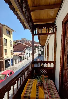 a balcony with a table and a view of a street at Imperial Cusco INN in Cusco