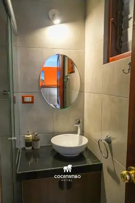 a bathroom with a sink and a mirror on a counter at Cocatambo in Ollantaytambo
