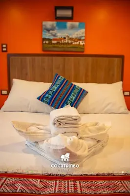 a tray of towels sitting on top of a bed at Cocatambo in Ollantaytambo