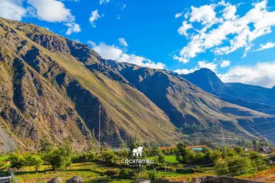a mountain with a white horse in front of it at Cocatambo in Ollantaytambo