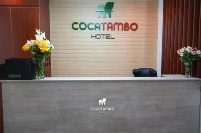a reception counter in a hotel with flowers on it at Cocatambo in Ollantaytambo