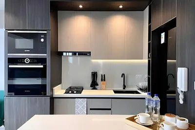 a kitchen with black and white appliances and a table at Edificio Olavegoya in Lima