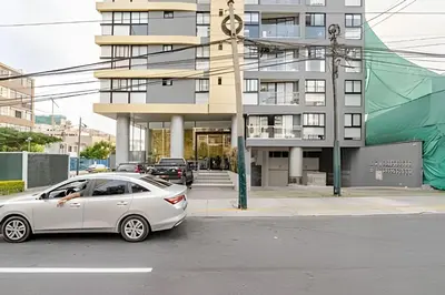 a white car parked in front of a building at Edificio Olavegoya in Lima