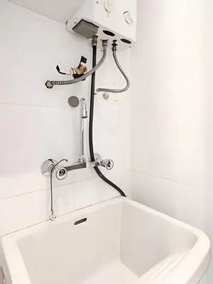a bathroom with a sink and a faucet at Edificio Olavegoya in Lima