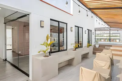 a lobby with tables and chairs and windows at Edificio Olavegoya in Lima