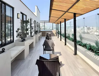 a lobby of a building with tables and chairs at Edificio Olavegoya in Lima