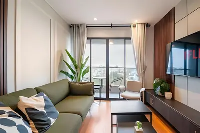 a living room with a couch and a tv at Edificio Parque Castilla in Lima