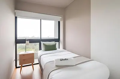 a white room with a bed and a window at Edificio Parque Castilla in Lima