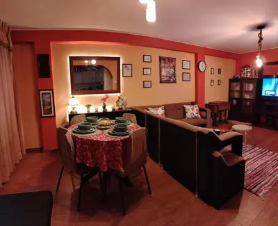 a living room with a table and a couch at Casa Hilda in Huancayo