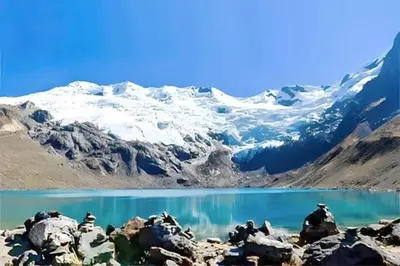 a lake with snow covered mountains in the background at Casa Hilda in Huancayo