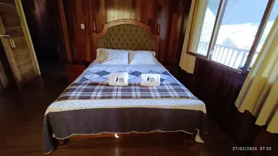 a bed with two pairs of shoes sitting on it at Ecolodge Don Felix in Quillabamba