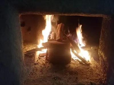 a brick oven with a fire in it at Jungle Lodge Quillabamba All included
