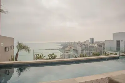 a swimming pool with a view of a city at Sight Oceanview in Barranco Malecon by Wynwood House in Lima