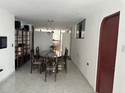 a dining room with a table and chairs at Casa de Stephano in Lima