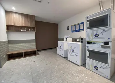 a kitchen with white appliances and a tv on the wall at New 1st Fl Executive Patio Pad in Lima
