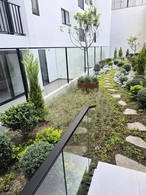 an internal courtyard of an office building with a garden at New 1st Fl Executive Patio Pad in Lima