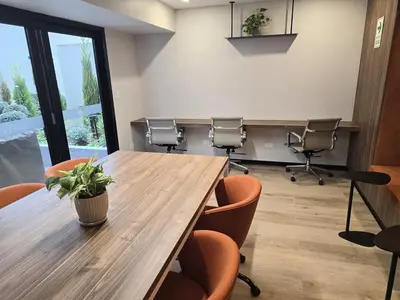 a conference room with a wooden table and chairs at New 1st Fl Executive Patio Pad in Lima
