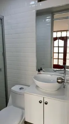 a white bathroom with a toilet and a sink at Habitación con Balcón Castellares La Puebla in Ayacucho