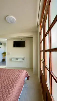 a bedroom with a bed and a flat screen tv at Habitación con Balcón Castellares La Puebla in Ayacucho