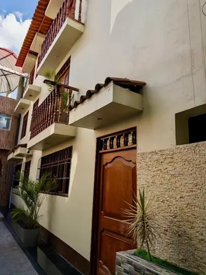 a house with a wooden door and a balcony at Habitación con Balcón Castellares La Puebla in Ayacucho