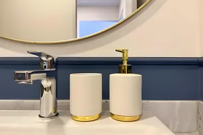 a bathroom with two rolls of toilet paper on a sink at Edificio Plaza 27 in Lima