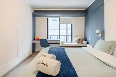 a bedroom with a large bed with a blue wall at Edificio Plaza 27 in Lima