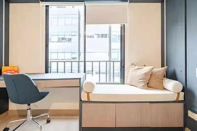 a bedroom with a bed and a desk and a chair at Edificio Plaza 27 in Lima