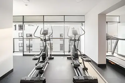 a row of cardio machines in a gym with a window at Edificio Vital in Lima