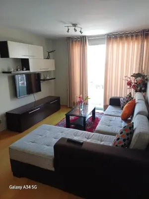 a living room with a couch and a table at Cómodo departamento familiar in Lima