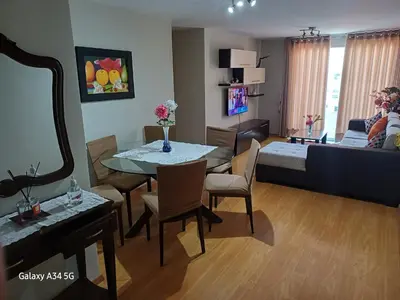 a living room with a dining table and a living room at Cómodo departamento familiar in Lima