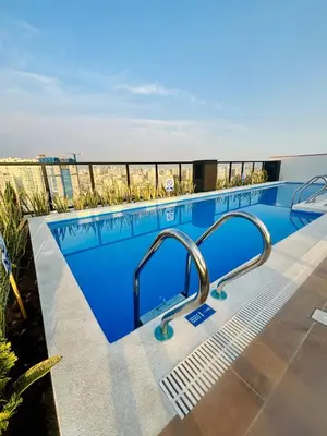 a swimming pool on the roof of a building at Modern and centrally located with a rooftop in Lima