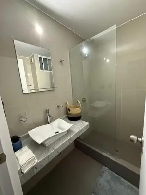 a bathroom with a sink and a shower with a mirror at The Palms at Miraflores in Lima